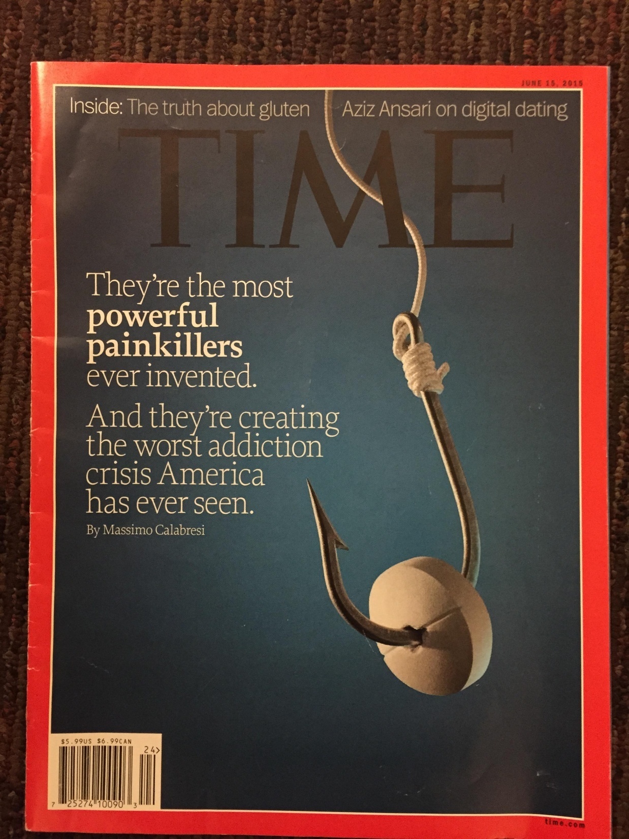 The cover of a Time magazine. The background is a solid blue color with the word "TIME" written in black white letters at the top. Below the word there is a quote from an article by Massimo Calabesi that reads "They're the most powerful painkillers ever invented. And they're creating the worst addiction crisis America has ever seen." The quote is written in a modern sans-serif font and is centered on the cover. On the right side of the cover there is a fish hook with a white pill hooked on it. 