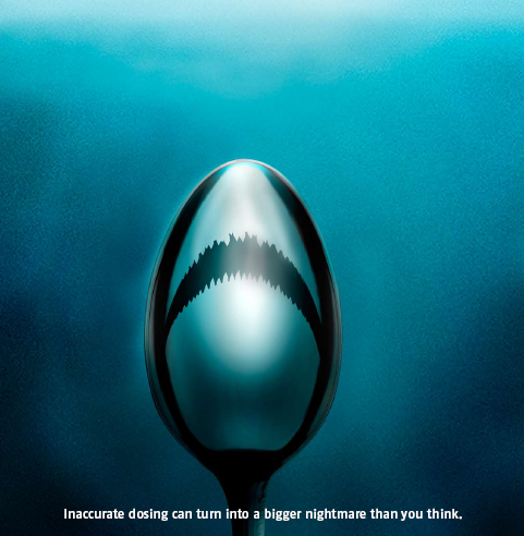 A digital art piece that features a spoon with a shark's mouth on it. The spoon is in the center of the image with the mouth open wide revealing sharp teeth. The background is a dark blue color and the spoon is positioned in the middle of the frame. The text on the image reads "Inaccurate dosing could be a nightmare waiting to happen."  The text is written in white and is in a modern sans-serif font. The overall tone of the piece is dark and ominous conveying a sense of fear and uncertainty.