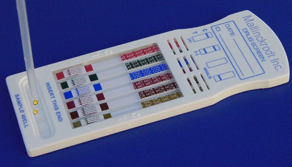 A white plastic device with a blue background. The device is labeled "Mallinckrodt Inc. Drug Screen." There is a small plastic dropper that is adding yellow cartoon drops possible representing urine into a part of the device labeled "Sample Well." The device has a rectangular shape with a curved top and a flat bottom. On the top there is a label that reads "Mallinckrodt Inc. Drug Screen" Below the label there are several rows of test strips with different colors and labels. The test strips are arranged in a grid-like pattern with each row containing a different color and label. At the bottom there is the sample well. 