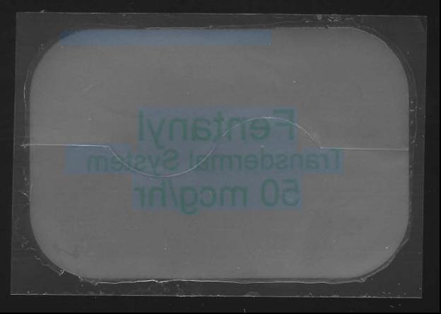 This image is a mirror image of a white rectangle with rounded edges that reads "Fentanyl [?] System 50 mcg/hr". The image has a black border.