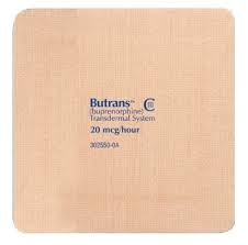 Of a rectangular-shaped object with a light beige color. The object appears to be made of a soft textured material with a grid-like pattern. On the top right corner of the object there is a blue label with the brand name "Butrans" written in white text. Below the label it reads "Buprenorphine Transdermal System" in black text. The label also mentions that the object is a 20-hour bandage.