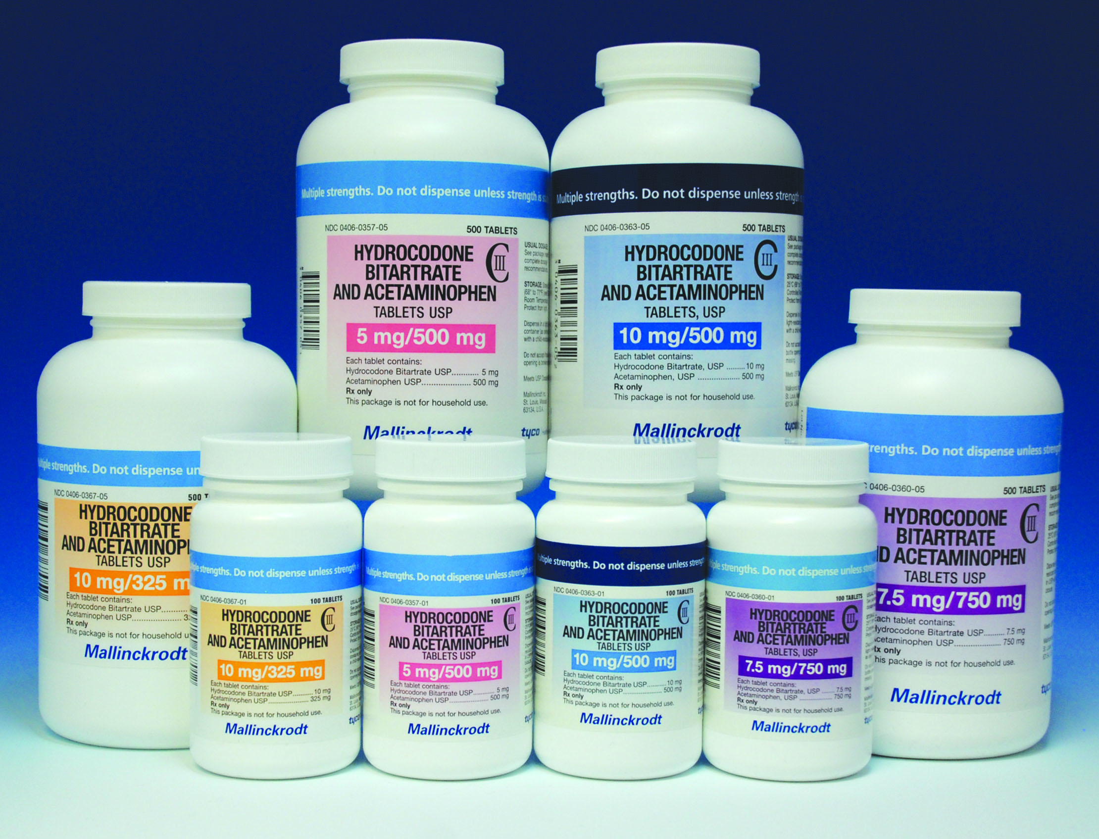 A group of eight white plastic bottles of hydrocodone bitartrate and acetaminophen tablets USP of various dosages with labels in various colors. The hydrocodone bitartrate comes in 5 mg 7.5 mg or 10 mg per pill. The acetaminophen comes in 325 mg 500 mg or 750 mg per pill. The bottles contain 100 or 500 pills per bottle.