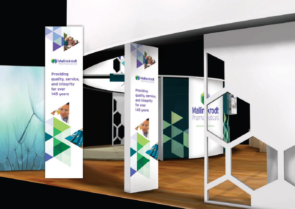 A trade show booth with a modern design. The booth has a white background with a geometric pattern in shades of blue green and purple. On the left side of the booth there is a large banner with the company's logo and contact information. The banner also has a photo of a man in a suit and tie and the text "Providing quality service quality assurance and quality assurance". On the right side there are two smaller banners with the same company's name and logo. In the center of the image there appears to be a large screen with a blue and green abstract design. <br /><br />The booth is set up on a wooden floor with a white wall in the background. There is also a large window on the left wall allowing natural light to enter the booth.